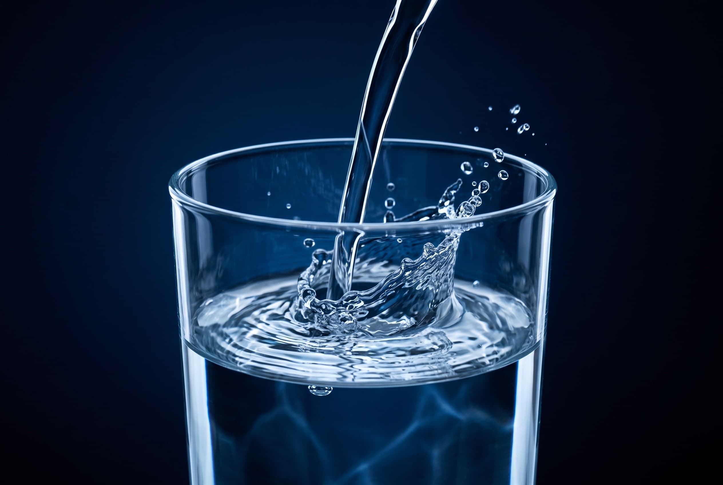 A glass of water being filled